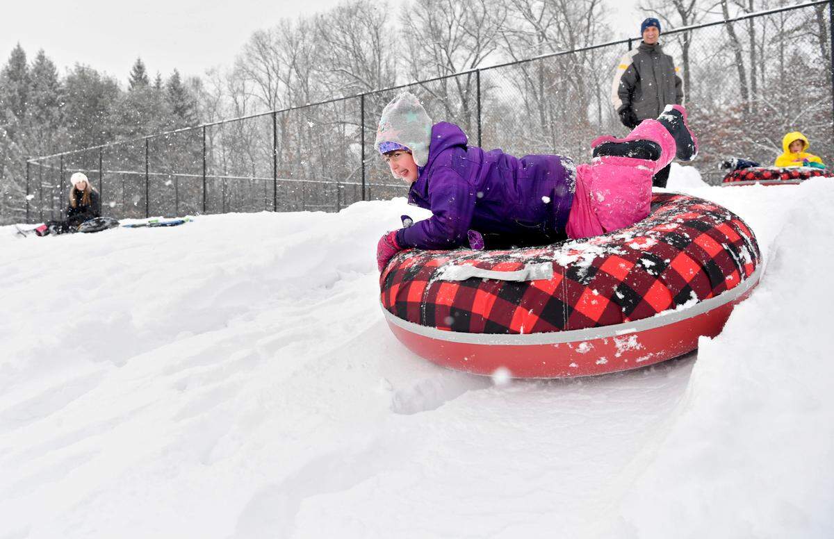 Molly Giebink, 5, dives onto her snow tube to sled down the hill at Circleville Park Feb. 1, 2021.  