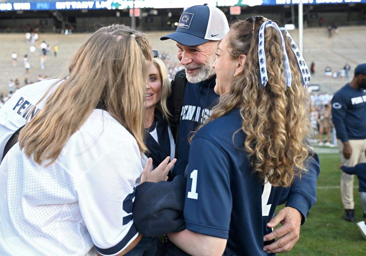 Penn State defensive coordinator Jim Knowles celebrates with family after the win over Nevada on Saturday, Aug. 30, 2025 at Beaver Stadium. 