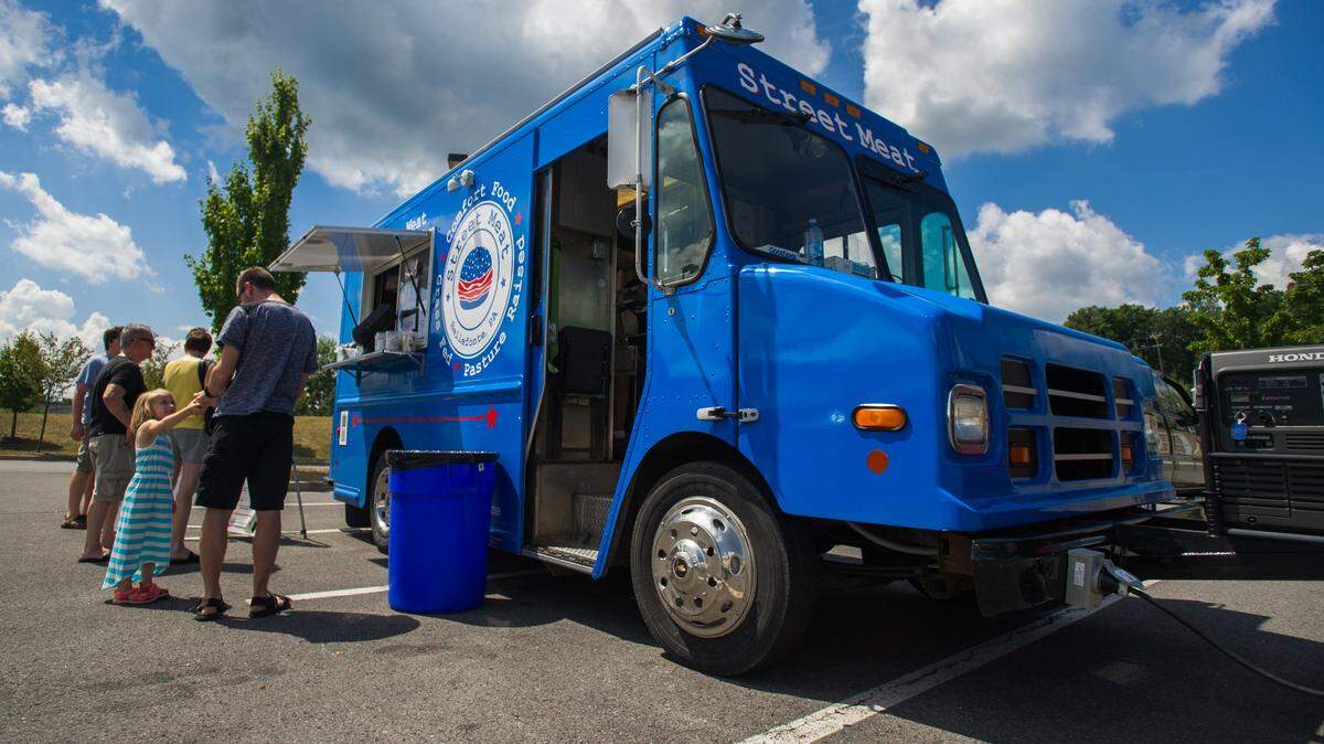 The Street Meat food truck serves customers at the North Atherton Farmers Market in the parking lot of Home Depot in August 2016.