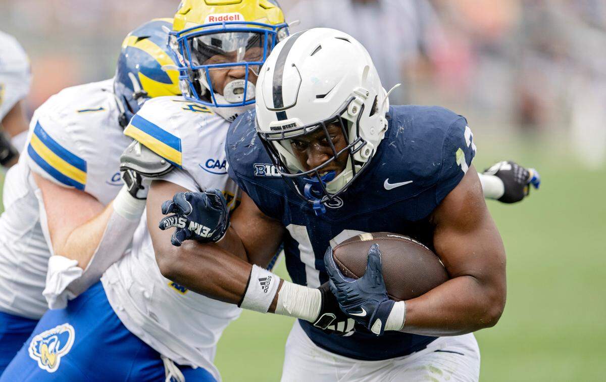 Penn State running back Kaytron Allen pushes past Delaware defenders during the game on Saturday, Sept. 9, 2023.