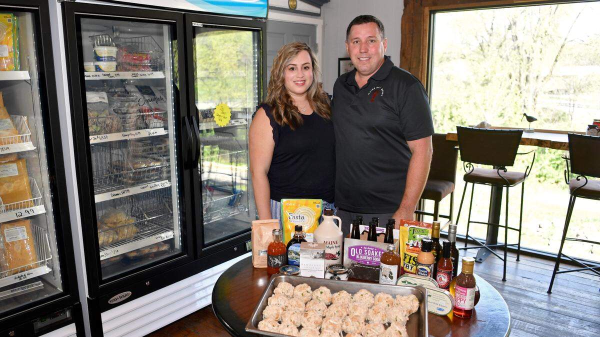 Christa Stofferahn and Shaun Knight pose on Tuesday with some of the products available at Maine Bay & Berry in Lemont.