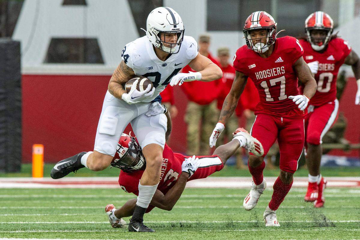 Penn State tight end Theo Johnson (84) slips out of a tackle by Indiana defensive back Tiawan Mullen (3) during the first half of an NCAA college football game, Saturday, Nov. 5, 2022, in Bloomington, Ind.