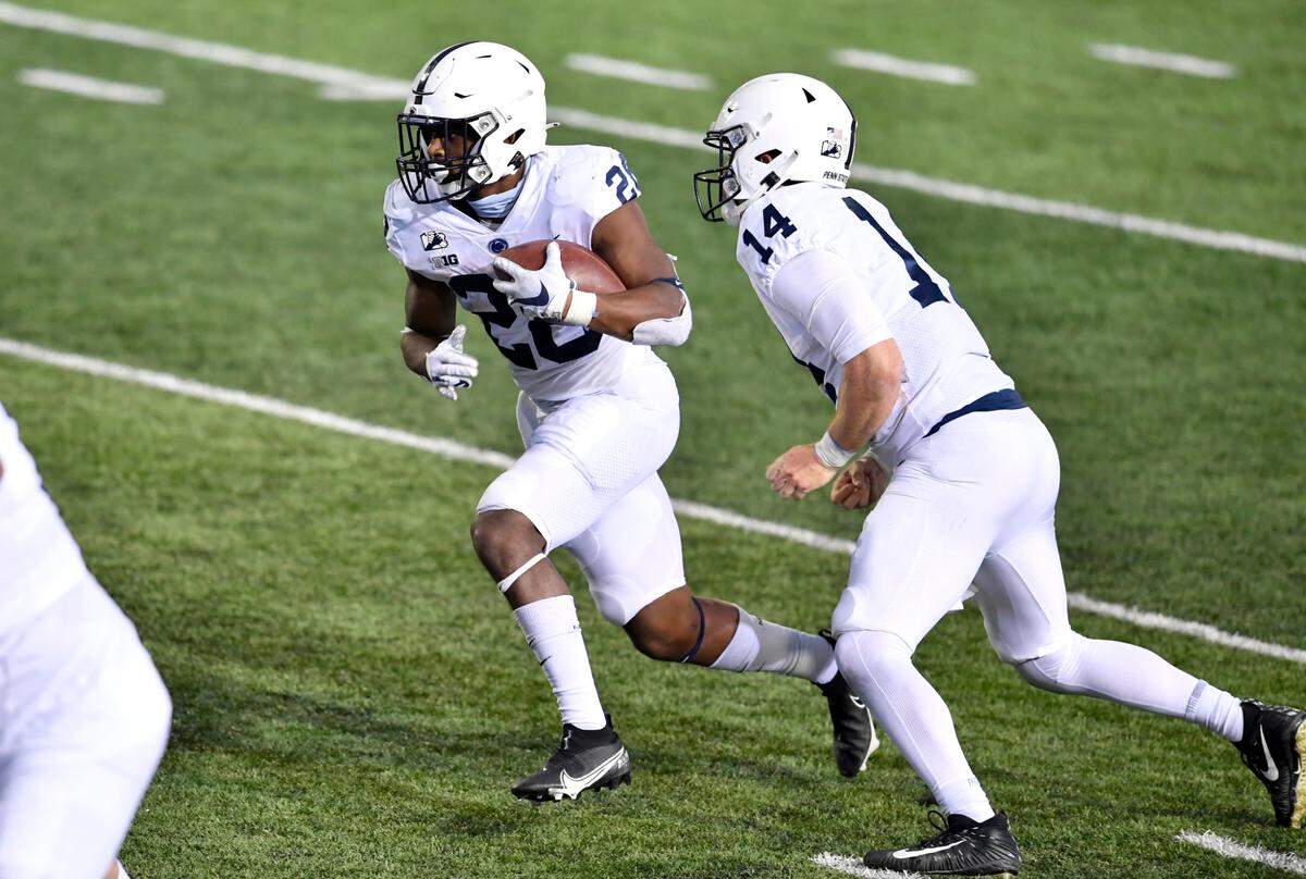 Penn State running back Devyn Ford takes the hand off from Sean Clifford and runs into the end zone for a touchdown with just minutes left of the game against Indiana on Saturday, Oct. 24, 2020 at Memorial Stadium.