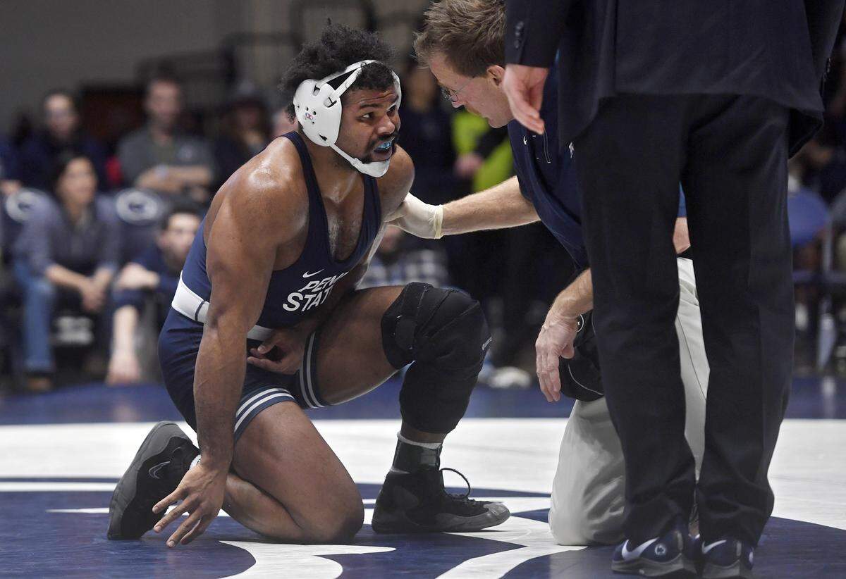 A trainer talks to Penn State’s Kyle Conel during his 197 lb bout against Penn’s Cole Urbas on Sunday, Dec. 8, 2019 at Rec Hall. Conel finished the bout and won by decision, 6-5.