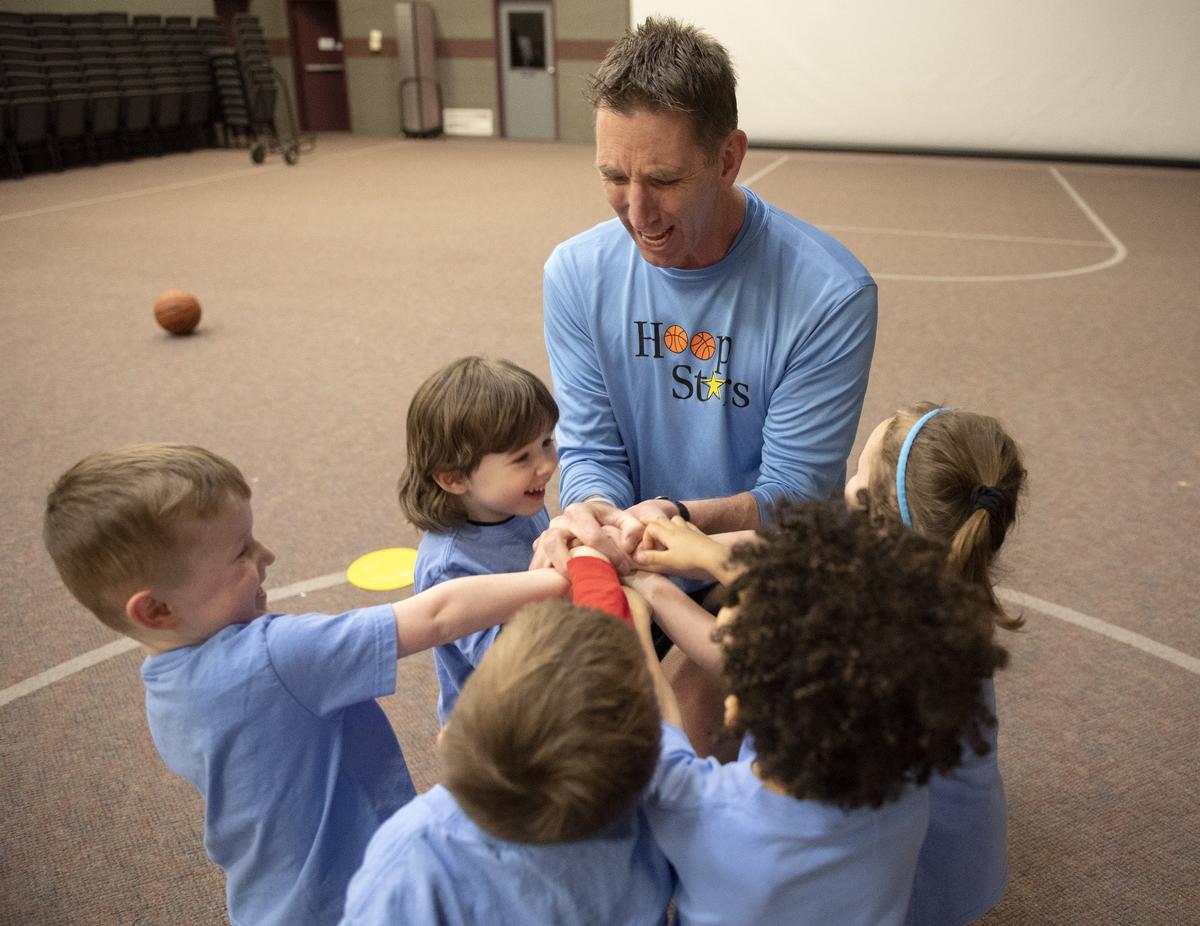 Dan McKenna gathers a class of preschoolers for a cheer to end a Hoops Stars class on March 4 at Park Forest Baptist Church.