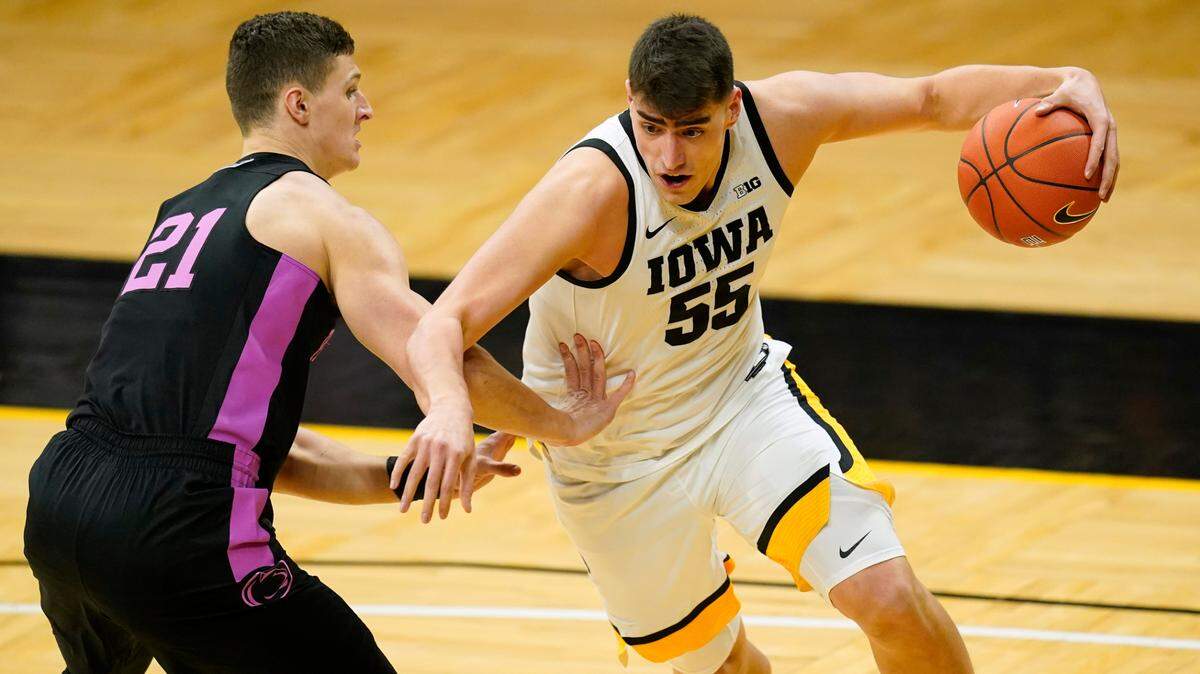 Iowa center Luka Garza drives past Penn State forward John Harrar, left, during the first half of an NCAA college basketball game, Sunday, Feb. 21, 2021, in Iowa City, Iowa.
