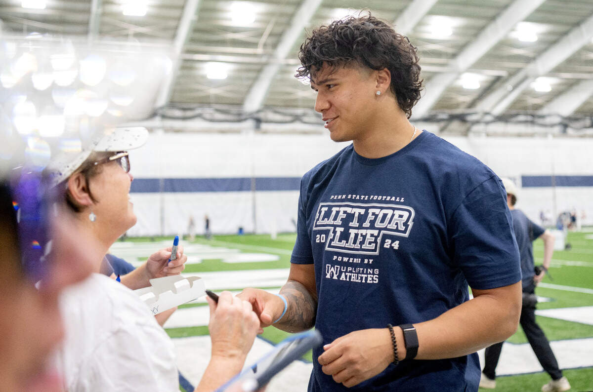 Penn State linebacker Tony Rojas signs autographs and talks with fans during the 21st Annual Lift for Life to benefit Uplifting Athletes on Thursday, June 13, 2024 in Holuba Hall.