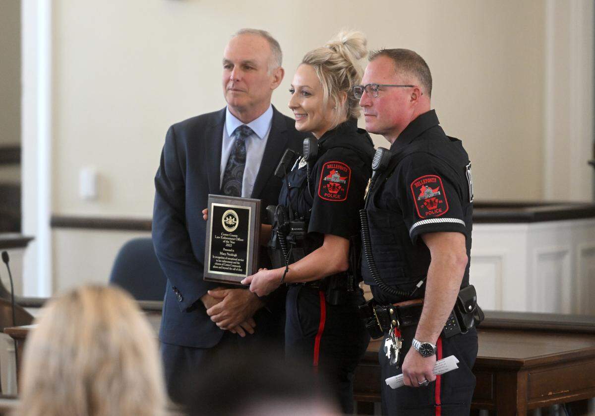 Bellefonte Police Department’s Macy Neideigh is congratulated by District Attorney Bernie Cantorna and Bellefonte Police Chief Shawn Weaver after being named one of the Law Enforcement Officers of the Year on Thursday, July 13, 2023.