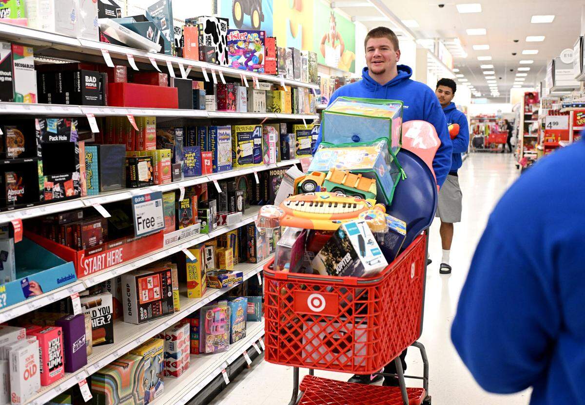 Penn State offensive lineman Cooper Cousins pushes his cart full of toys through Target during a shopping trip for Toys for Tots on Monday, Dec. 2, 2024.