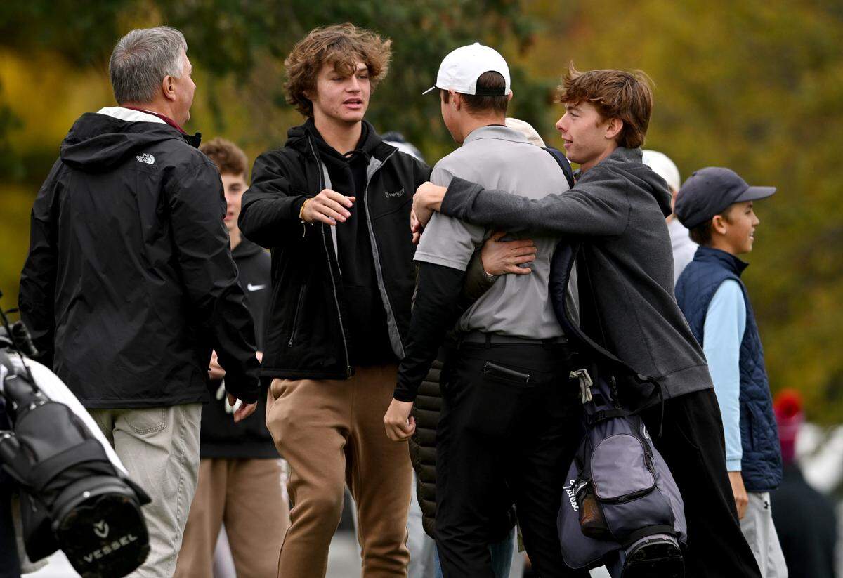 Friends hug State College’s Max Wager after he finished the his round in the PIAA golf championships at the Penn State Golf Courses on Tuesday, Oct. 17, 2023.
