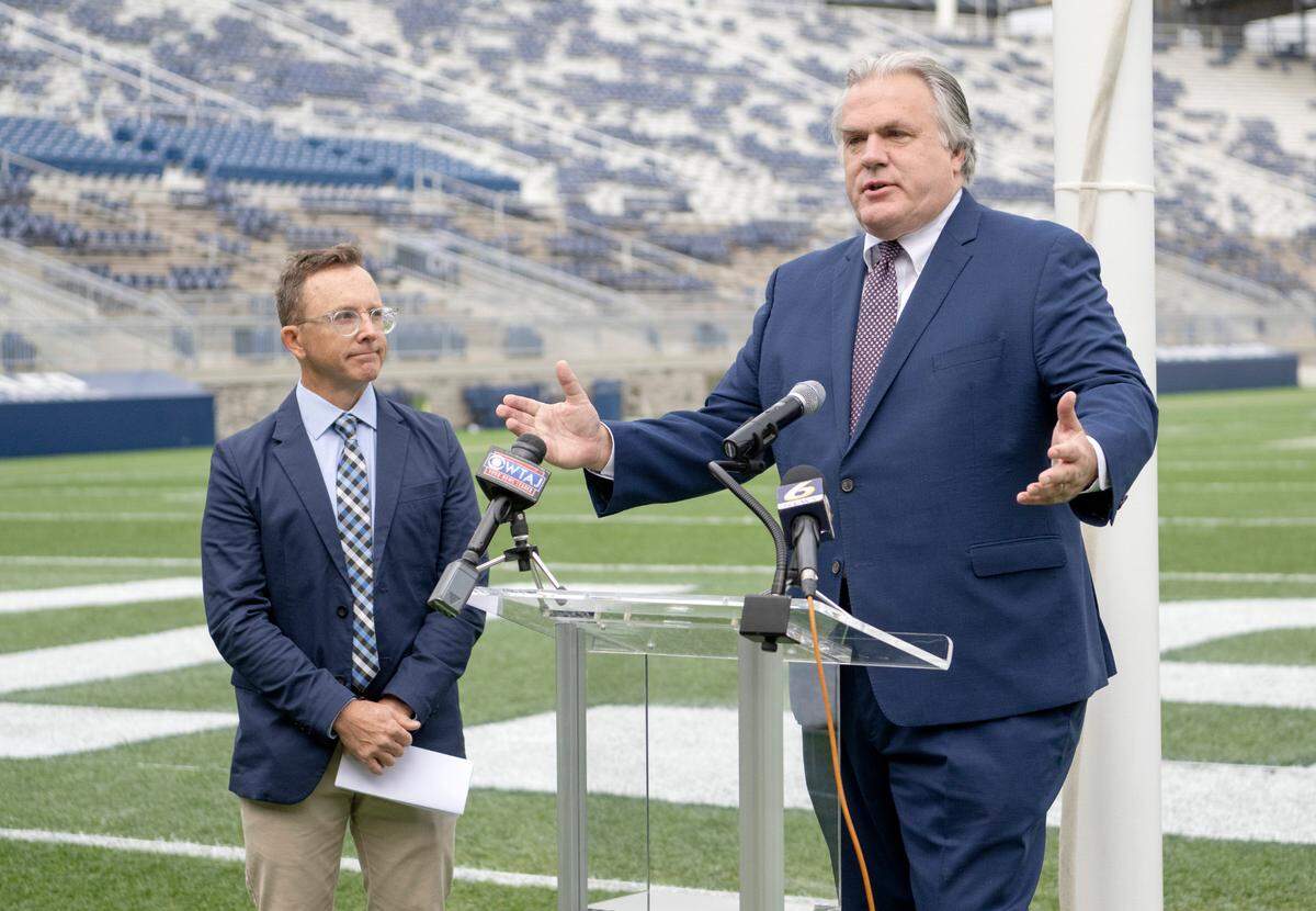 Fritz Smith from the Happy Valley Adventure Bureau announces the Ironman 70.3 Happy Valley Triathlon on Thursday at Beaver Stadium. Competitors will finish the race July 2, 2023 in the stadium.