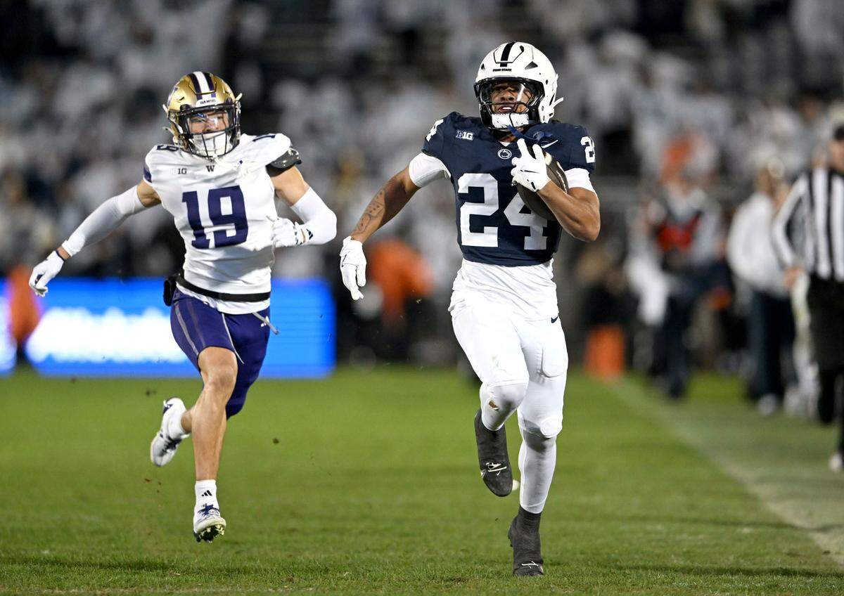 Penn State running back Corey Smith cuts down the field with the ball from Washington defenders during the game on Saturday, Nov. 9, 2024.