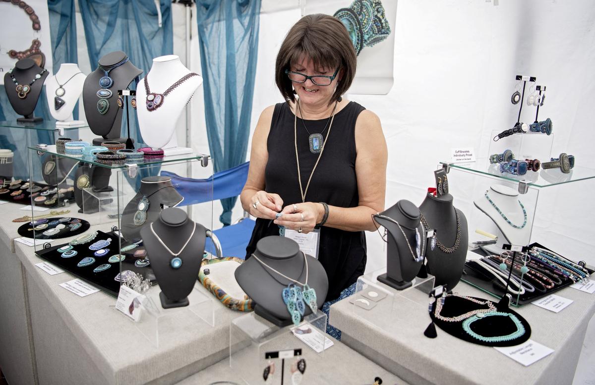 Megan Horan works on a piece of jewelry at the Central Pennsylvania Festival of the Arts on Thursday, July 11, 2019. Megan’s Jewelry Box uses Japanese seed beads to create her woven and bead embroidered pieces.