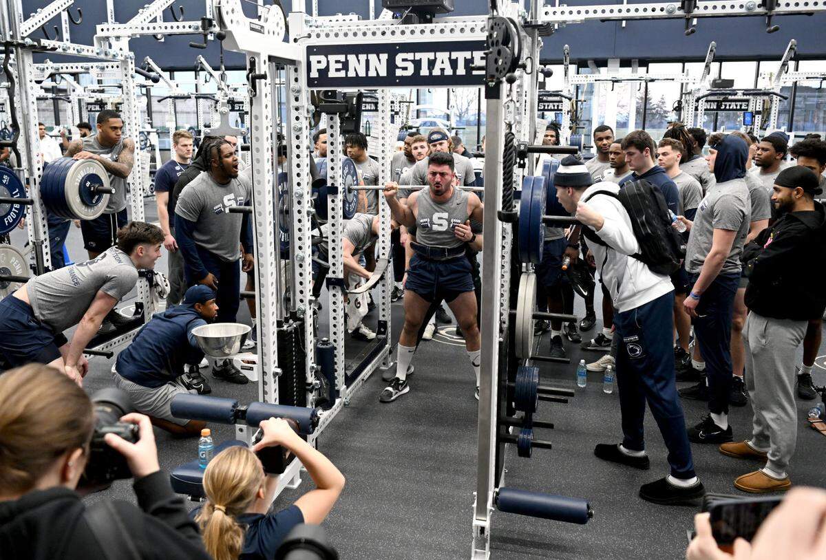 Teammates cheer for Penn State linebacker Dominic DeLuca as he lifts during a winter workout session on Thursday, Feb. 29, 2024.