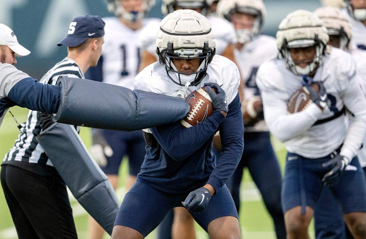 Penn State running back Nick Singleton runs a ball security drill during practice on Wednesday, Nov. 9, 2022.