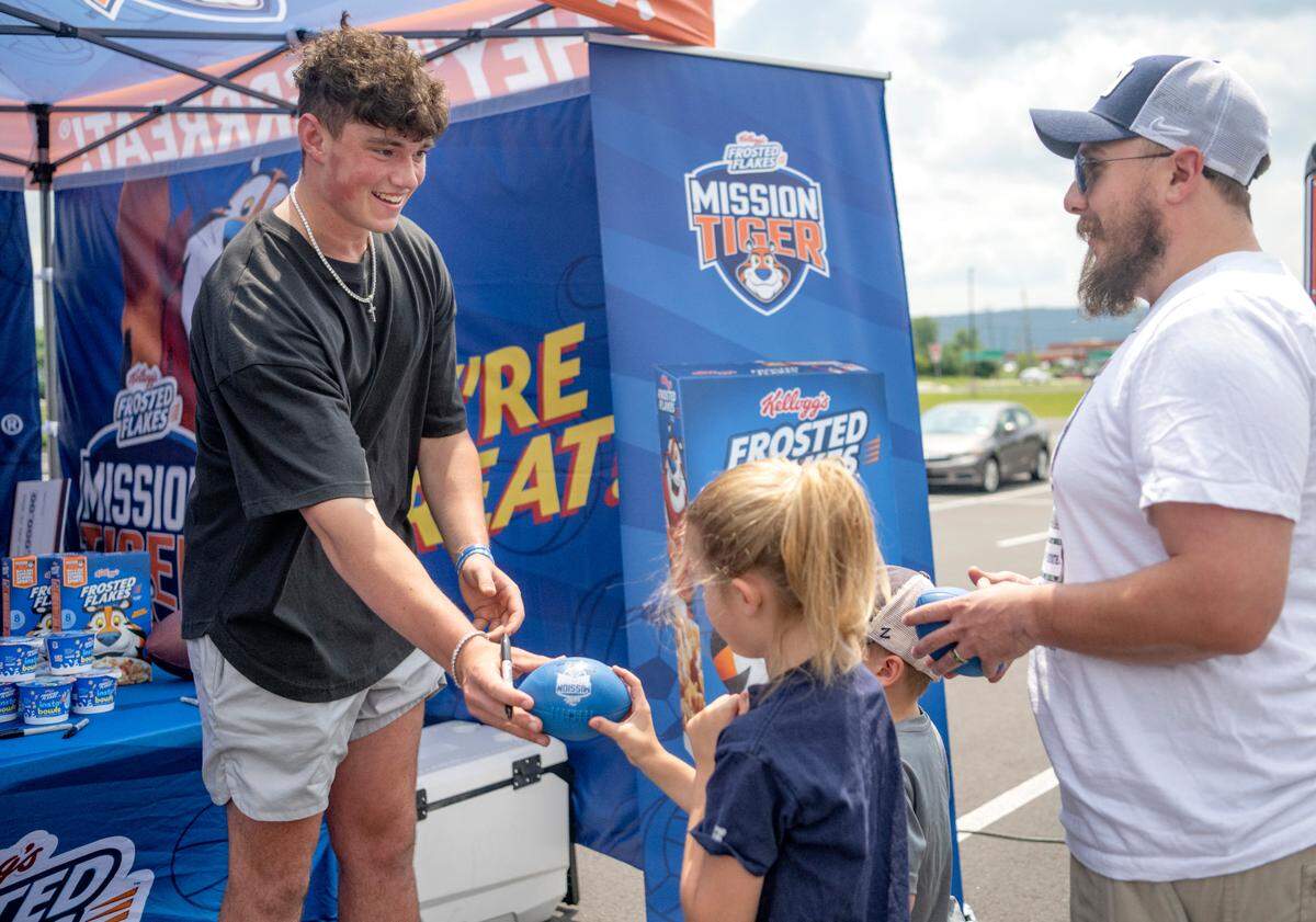 Penn State quarterback Drew Allar signs autographs for fans as he teamed up Kellogg’s Frosted Flakes and Mission Tiger Project outside of the Giant on Benner Pike on Wednesday, July 12, 2023.