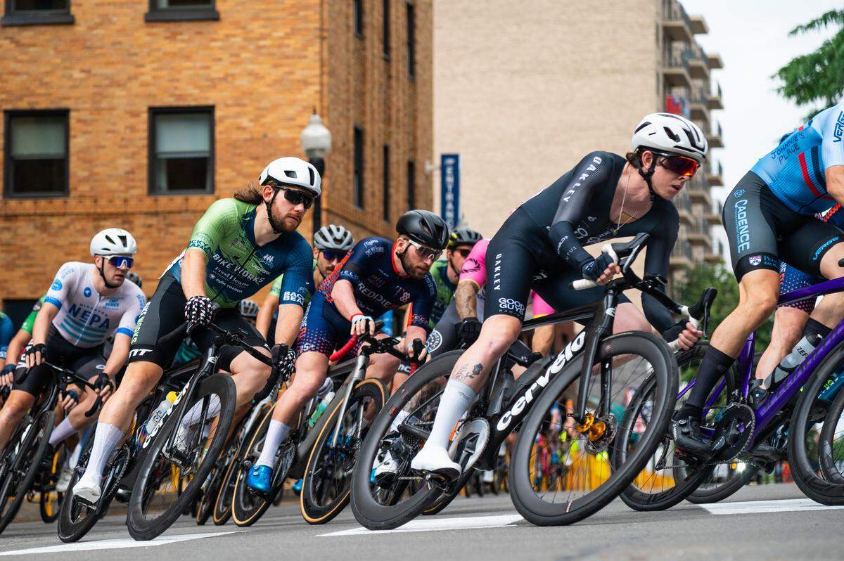Participants in the Men’s Cat 1 and Cat 2 cycling race go around the first corner during the State College Criterium on Saturday, July 26, 2025 in State College, Pa.