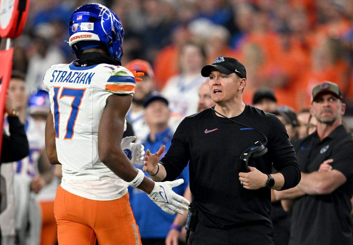 Boise State coach Spencer Danielson talks to Prince Strachan as he comes off the field during the Fiesta Bowl on Tuesday, Dec. 31, 2024 at State Farm Stadium.