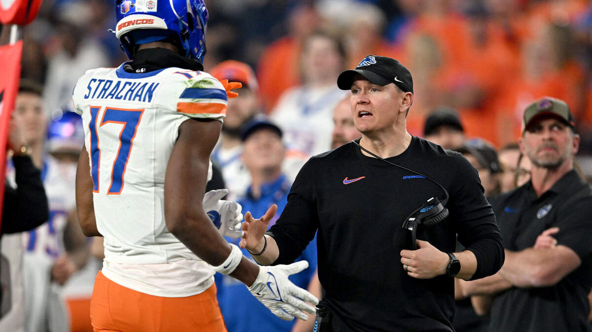 Boise State coach Spencer Danielson talks to Prince Strachan as he comes off the field during the Fiesta Bowl on Tuesday, Dec. 31, 2024 at State Farm Stadium.