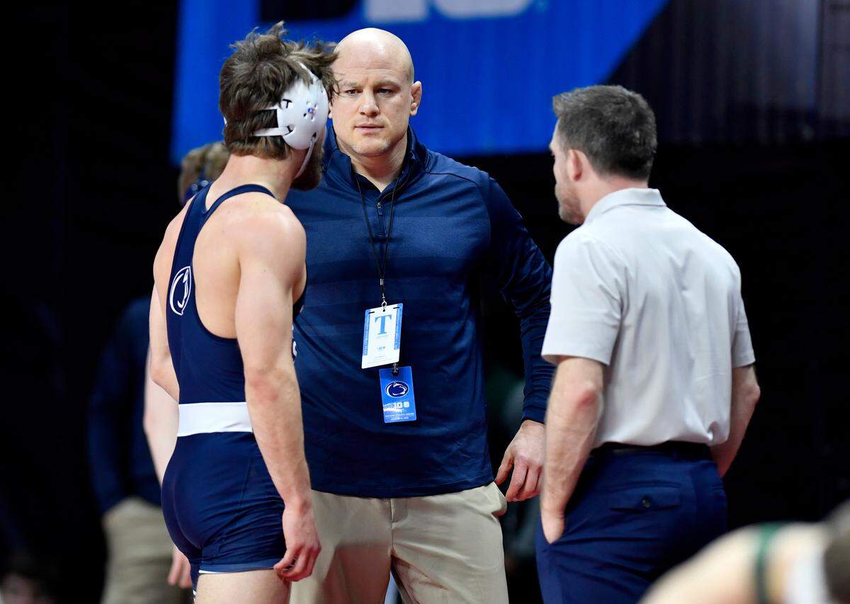 Penn State wrestling coach Cael Sanderson talks to Bo Pipher during his bout in the first round of the Big Ten Wrestling championships at Rutgers on Saturday, March, 7, 2020.