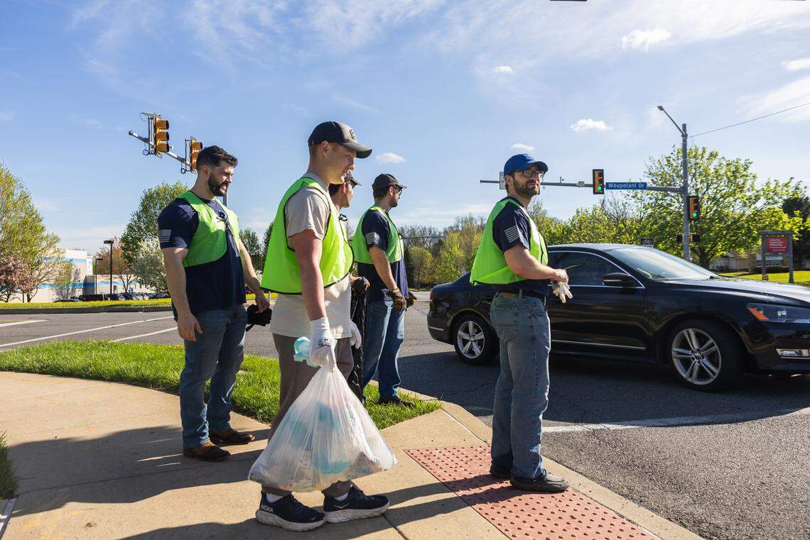 Members of the Omega Delta Sigma veterans fraternity collect trash along Waupelani Drive in State College, Pa., on Saturday, April 18, 2026. The ClearWater Conservancy organized volunteers across Centre County to clean up public green spaces.
