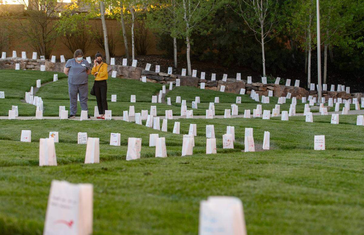 People walk among the luminaries at the Mount Nittany Health Medical Center Healing Garden during the “Luminary Reflection: An evening of Recognition, Remembrance, Gratitude and Hope,” on Monday.