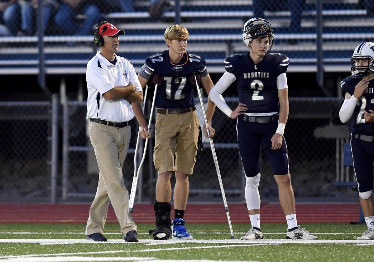 Philipsburg-Osceola football coach Brian McGonigal talks with injured quarterback Ryan Whitehead and fill in quarterback Jeremy Whitehead during the game on Friday, Sept. 27, 2019.