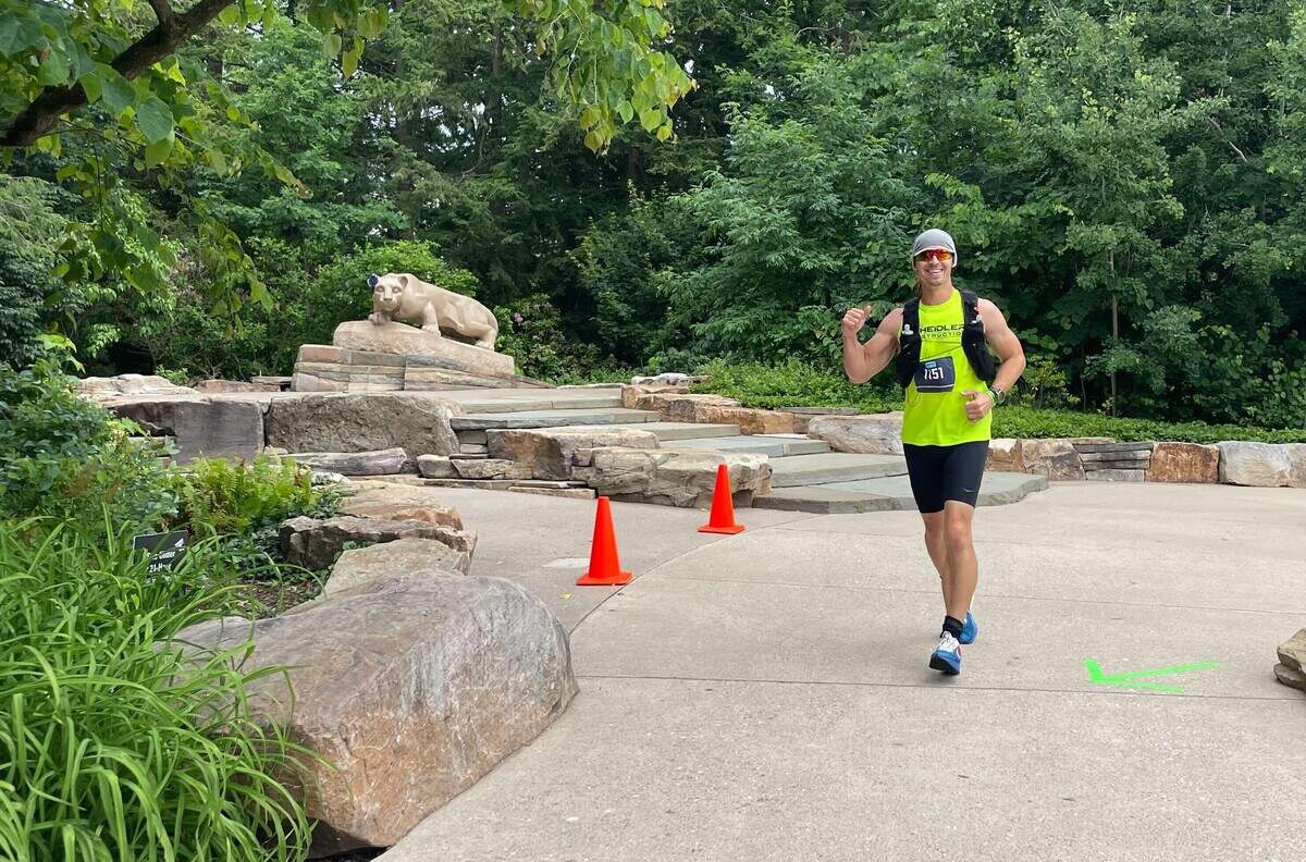 Bob Scheidler sprints past the Nittany Lion statue on Penn State’s campus Sunday, June 14, 2026, at the Ironman 70.3 Pennsylvania Happy Valley North American Championship in Centre and Clinton counties.