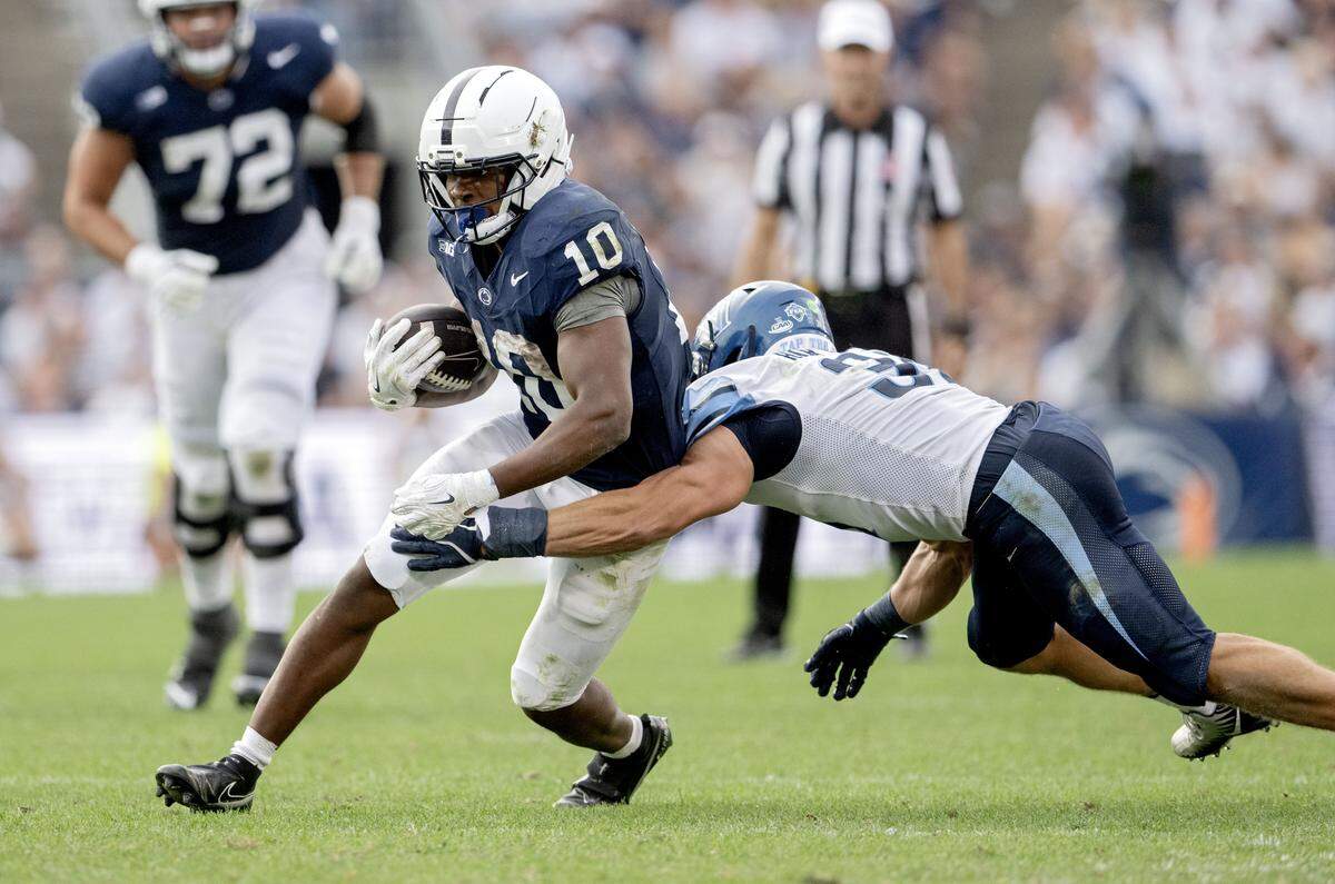 Penn State running back Nick Singleton runs with the ball from a Villanova defender during the game on Saturday, Sept. 13, 2025.
