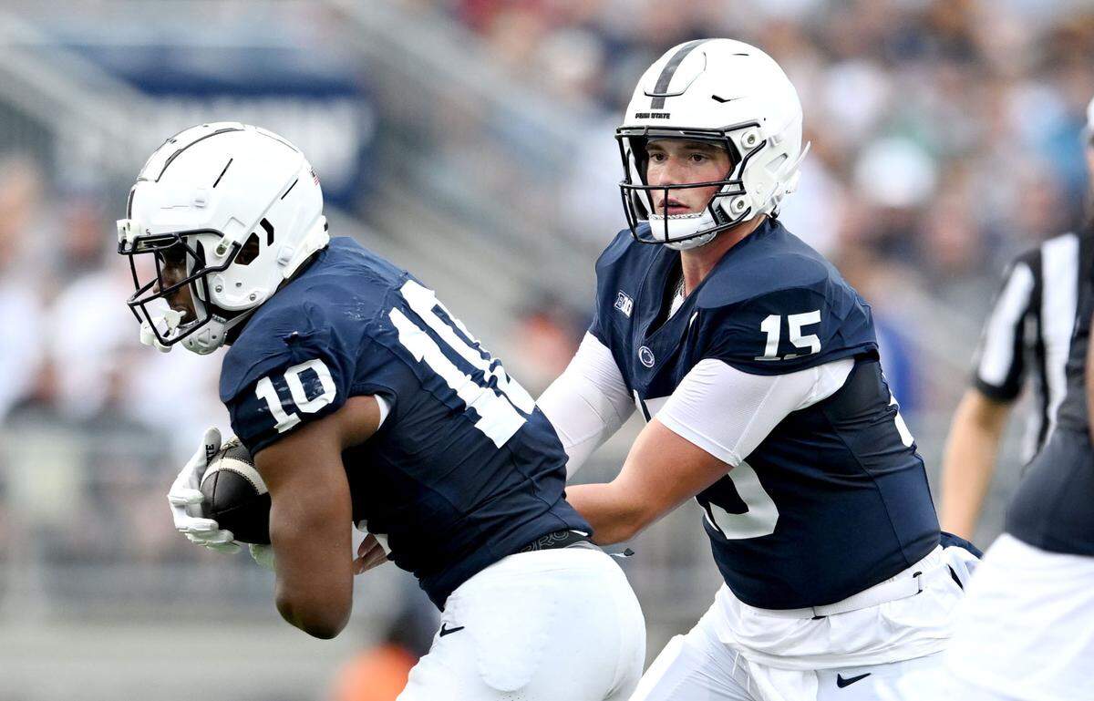 Penn State quarterback Drew Allar hands off to running back Nick Singleton during the game against Kent State on Saturday, Sept. 21, 2024 at Beaver Stadium.
