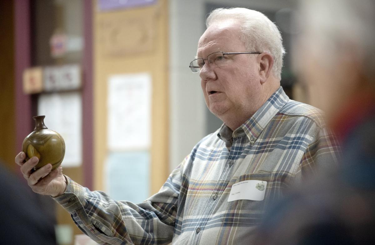 Nittany Valley Woodturners president Reg Groeke talks about a twig pot during the group’s March meeting.