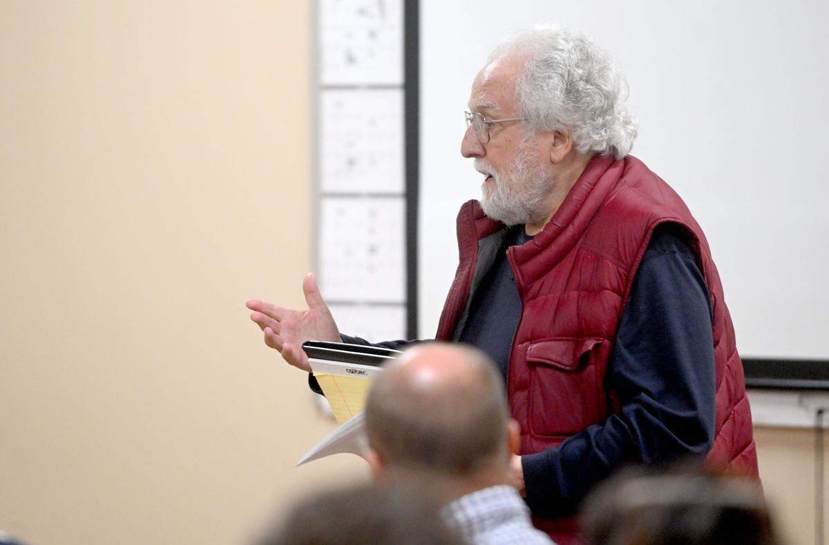 Thomas Berner tries to give a check to the Benner Township supervisors to pay for coverage by C-NET during an Oct. 7 meeting.