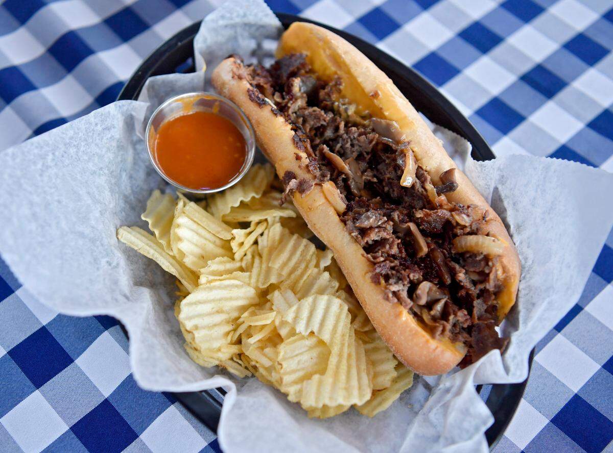 A Philly cheesesteak with a side of hot sauce at the We Are Inn in Philipsburg. 