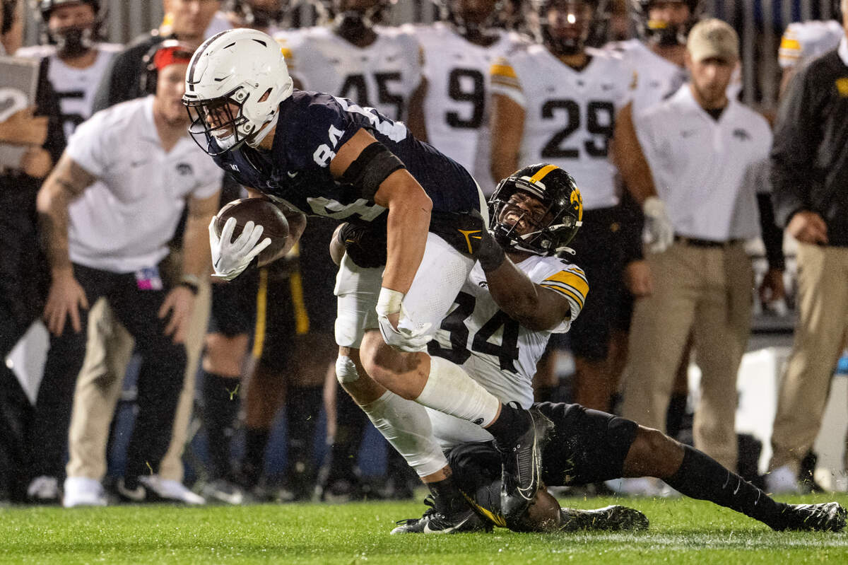 Iowa’s Jay Higgins tries to pull down Penn State tight end Theo Johnson during the game on Saturday, Sept. 23, 2023.