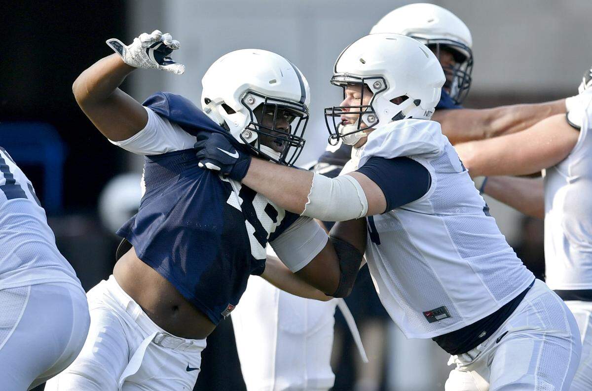 Penn State defensive end Daniel Joseph tires to push past offensive lineman Mike Miranda in a play during practice on Wednesday, August 15, 2018.