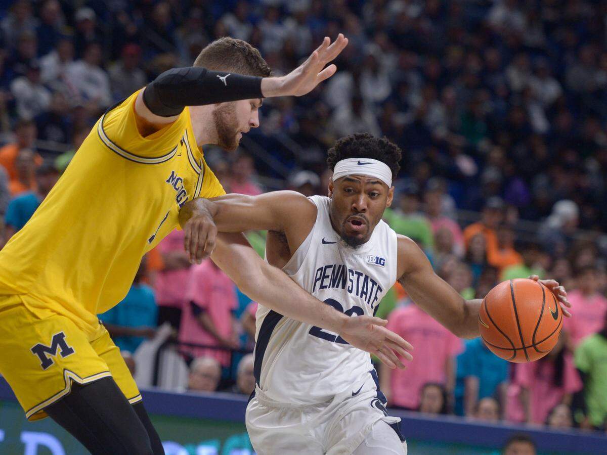Penn State’s Jalen Pickett drives to the basket on Michigan’s Hunter Dickinson during the first half of Sunday’s game at the Bryce Jordan Center.