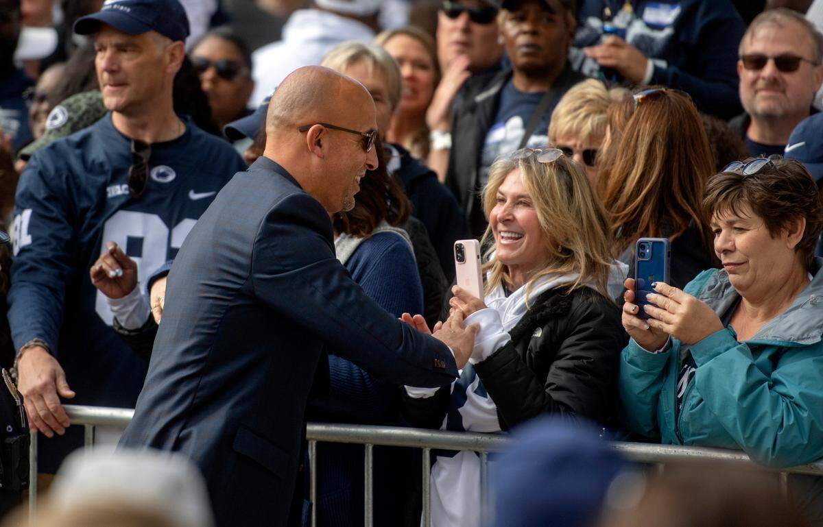 Penn State football coach James Franklin greets fans as he and the team arrive at Beaver Stadium for the game on Saturday, Sept. 24, 2022.