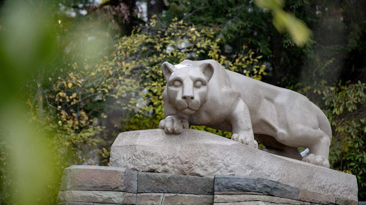 Fall leaves and snow at the Nittany Lion shrine on the Penn State University Park campus on Tuesday, Nov. 11, 2025.