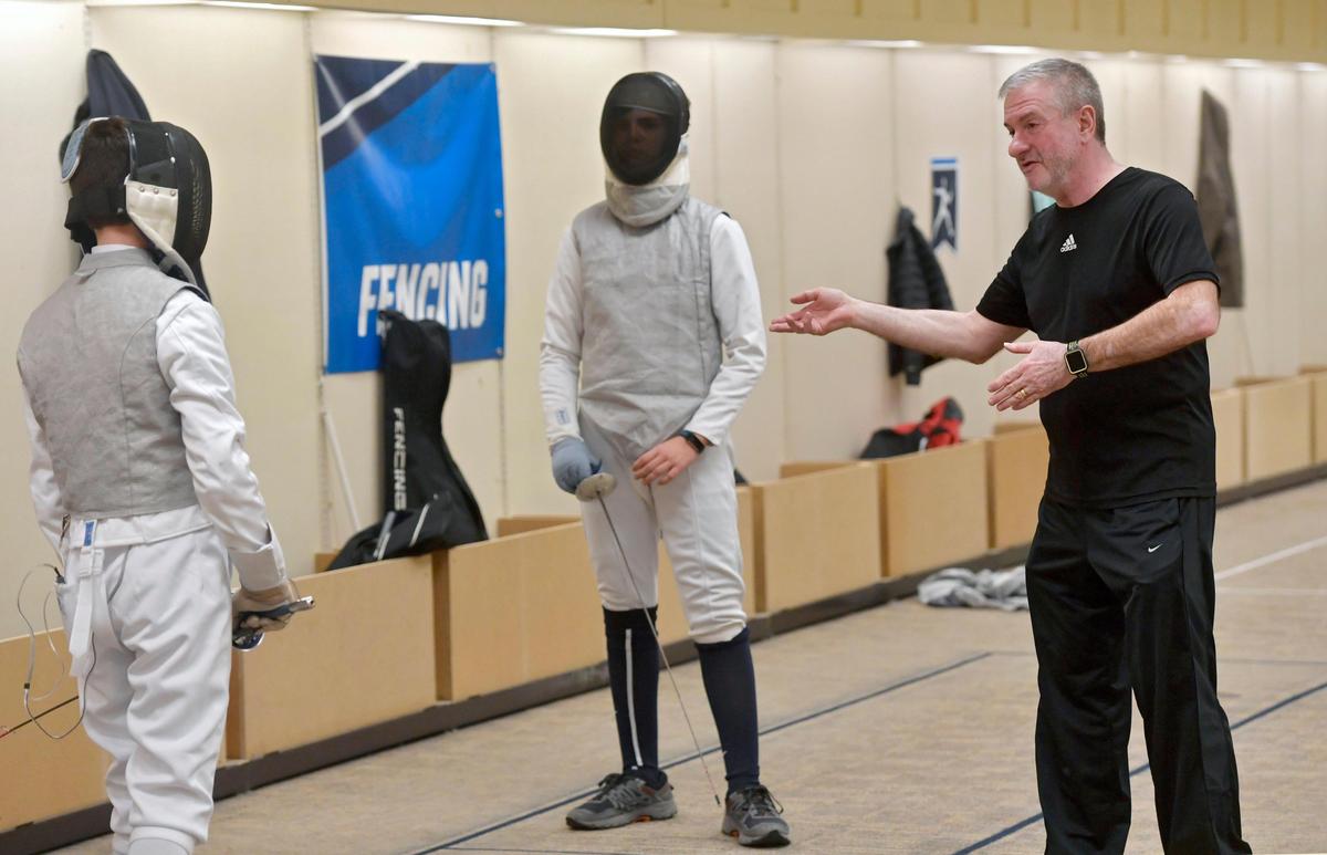 Coach Chuck Andrasko talks to a pair of fencers at the Nittany Fencing Academy on Tuesday, Dec. 17, 2019.