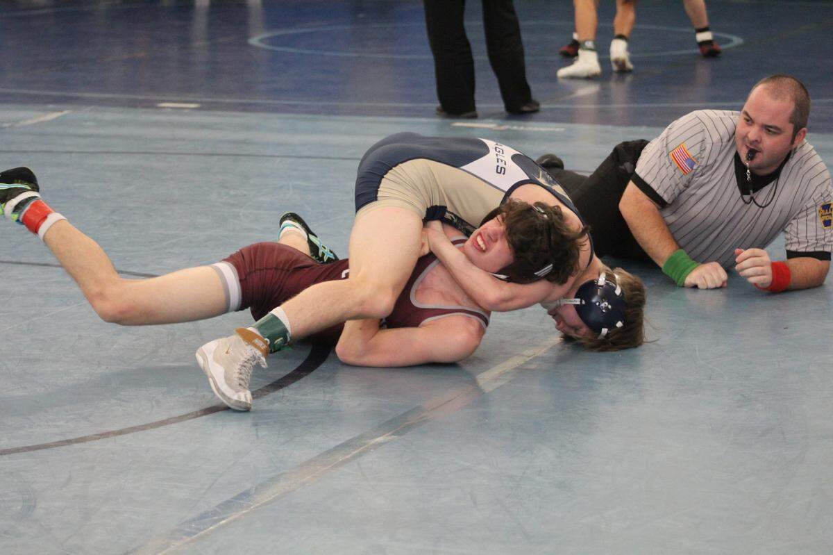Bald Eagle Area’s Coen Bainey pins State College’s Thomas Hill in their 127-pound first round match of the King of the Mountain tournament. It was the 100th career win for Bainey.