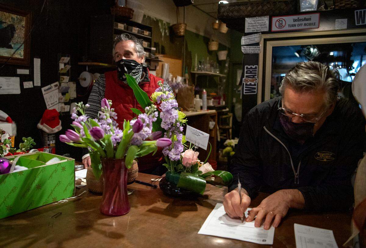 Mitch Ballas and Randy Ammerman behind the counter at George’s Floral Boutique on Thursday, Jan. 7, 2021.