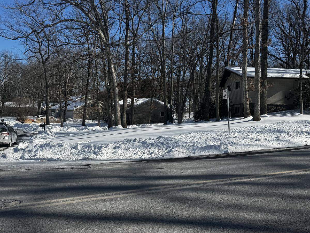 The shoulder is covered in snow at a bus stop in Toftrees Feb. 2, 2026.