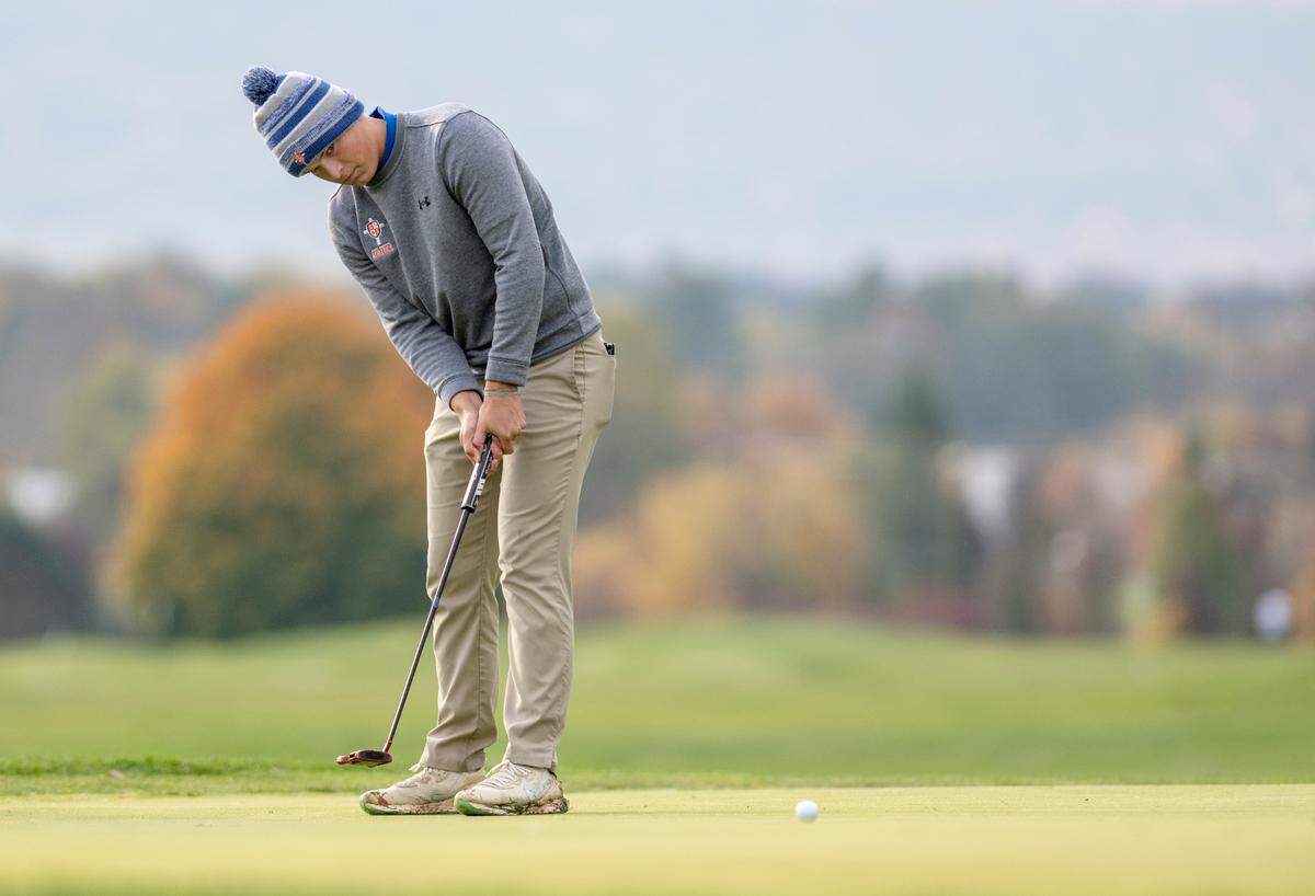 Saint Joseph’s Catholic Academy’s Tim Peters watches his putt during the PIAA golf championships on Monday, Oct. 17, at the Penn State Golf Courses.