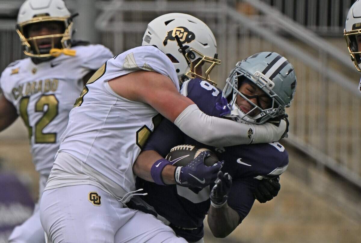 MANHATTAN, KS - NOVEMBER 29:  Defensive end Alexander McPherson #98 of the Colorado Buffaloes tackles  Qua Moss #6 of the Kansas State Wildcats in the second half at Bill Snyder Family Football Stadium on November 29, 2025 in Manhattan, Kansas. (Photo by Peter Aiken/Getty Images)