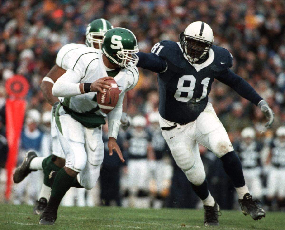 Penn State’s Michael Haynes (81) puts pressure on Michigan State quarterback Damon Dowdell, forcing him to throw a pass that was ruled intentional grounding in the first quarter of the game at Beaver Stadium on November 23, 2002.