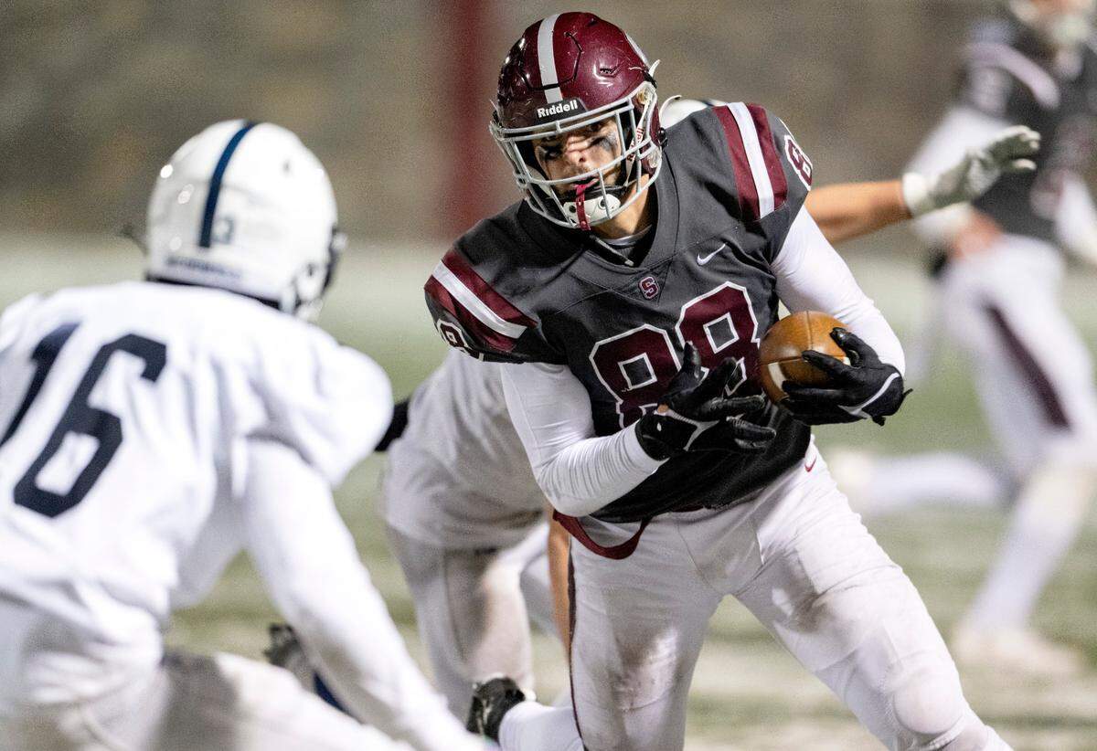 State College’s Stephen Scourtis cuts down the field with the ball from McDowell defenders during the game on Friday, Nov. 18, 2022.