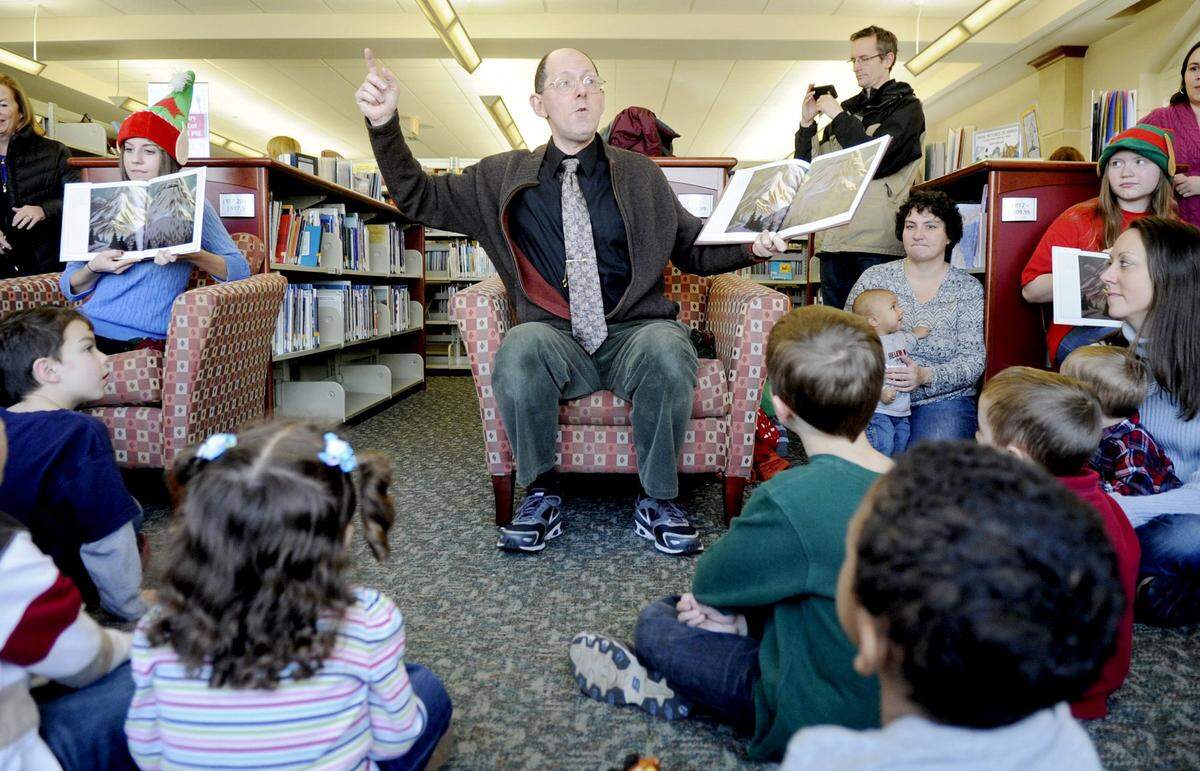 Mark Ballora reads the holiday classic, Polar Express to youngsters at the Schlow LIbrary on Saturday, December 15, 2012.