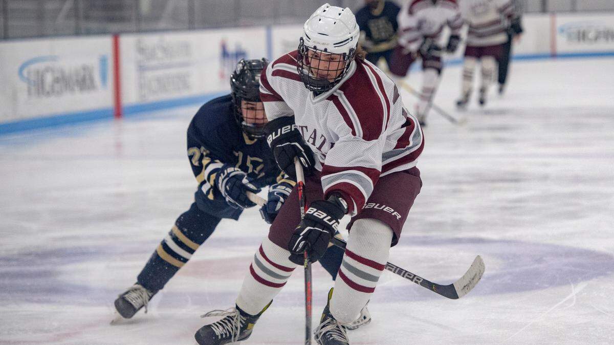State College’s Zander Faust skates down the ice ahead of a Hollidaysburg defender during the game on Thursday, Jan. 27, 2022.
