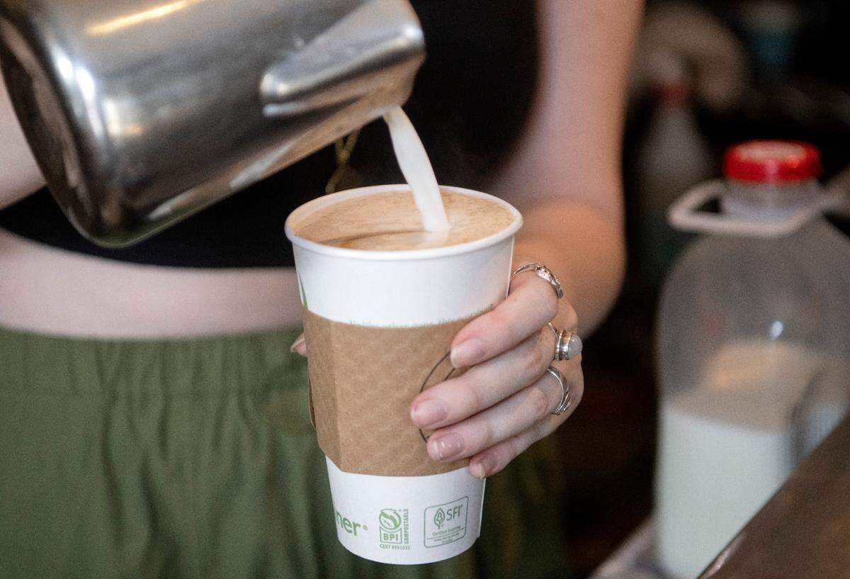 Lelaina Scott makes a cappuccino at Cafe Lemont2023 photo.