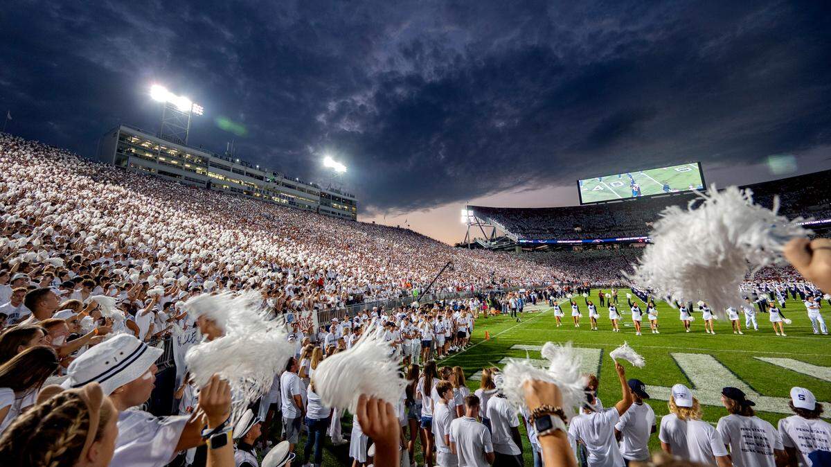 The sun sets over Beaver Stadium as the Blue Band performs before the Penn State football game against Auburn on Saturday, Sept. 18, 2021.
